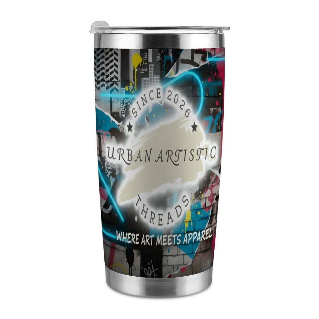 Urban Artistic Threads travel mug featuring graffiti cityscape art and the "Where Art Meets Apparel" slogan.