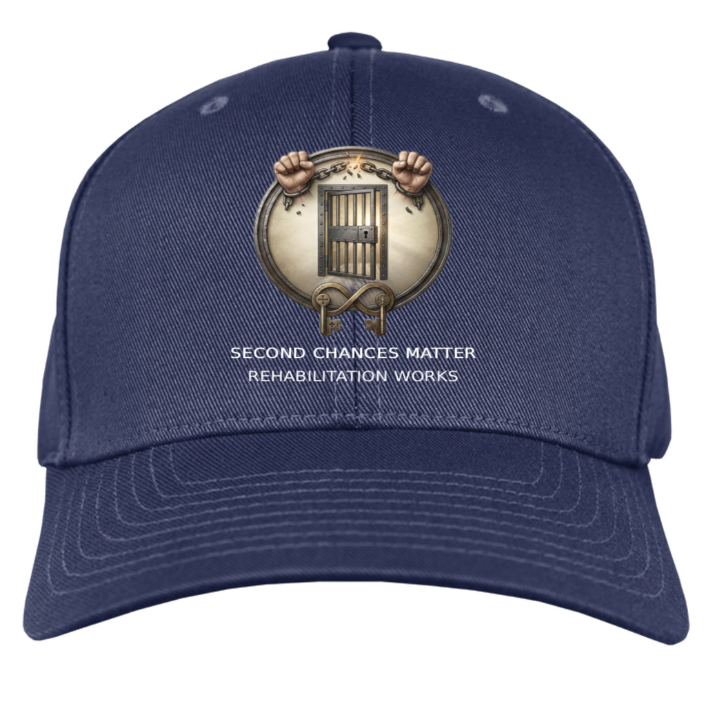Navy cap with circular badge showing chained hands in front of a jail door and "Second Chances Matter" text.