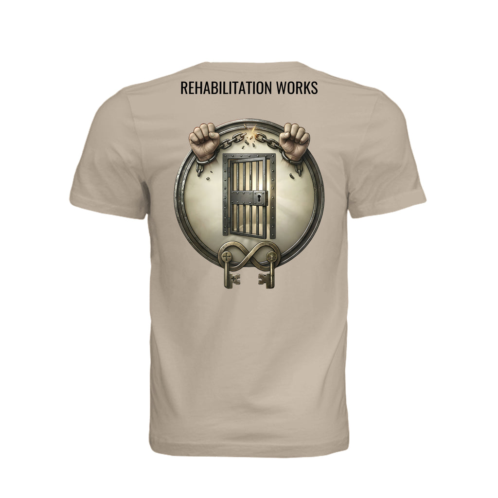 Rehabilitation Works beige tee featuring breaking chains, prison bars, and keys to symbolize second chances and recovery advocacy.