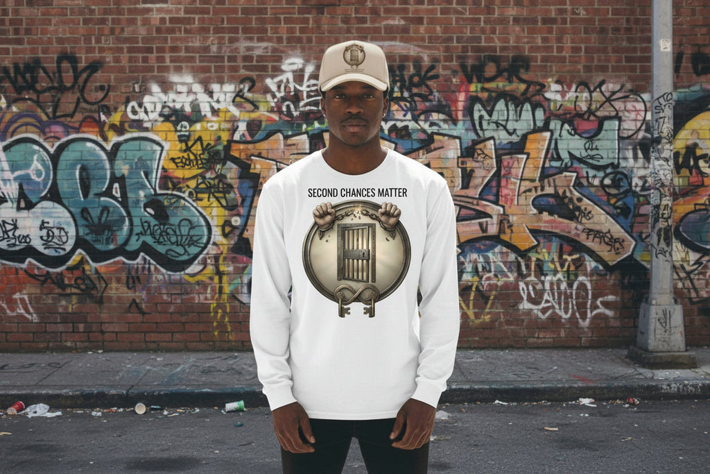 White long sleeve tee featuring "Second Chances Matter" graphic with breaking chains, prison door, and keys against a graffiti wall.